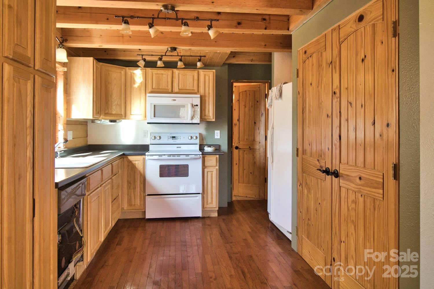 155 Northridge Drive, Unit 79 Rutherfordton, NC 28139 - Photo 8 of 31 a kitchen with white cabinets and white appliances