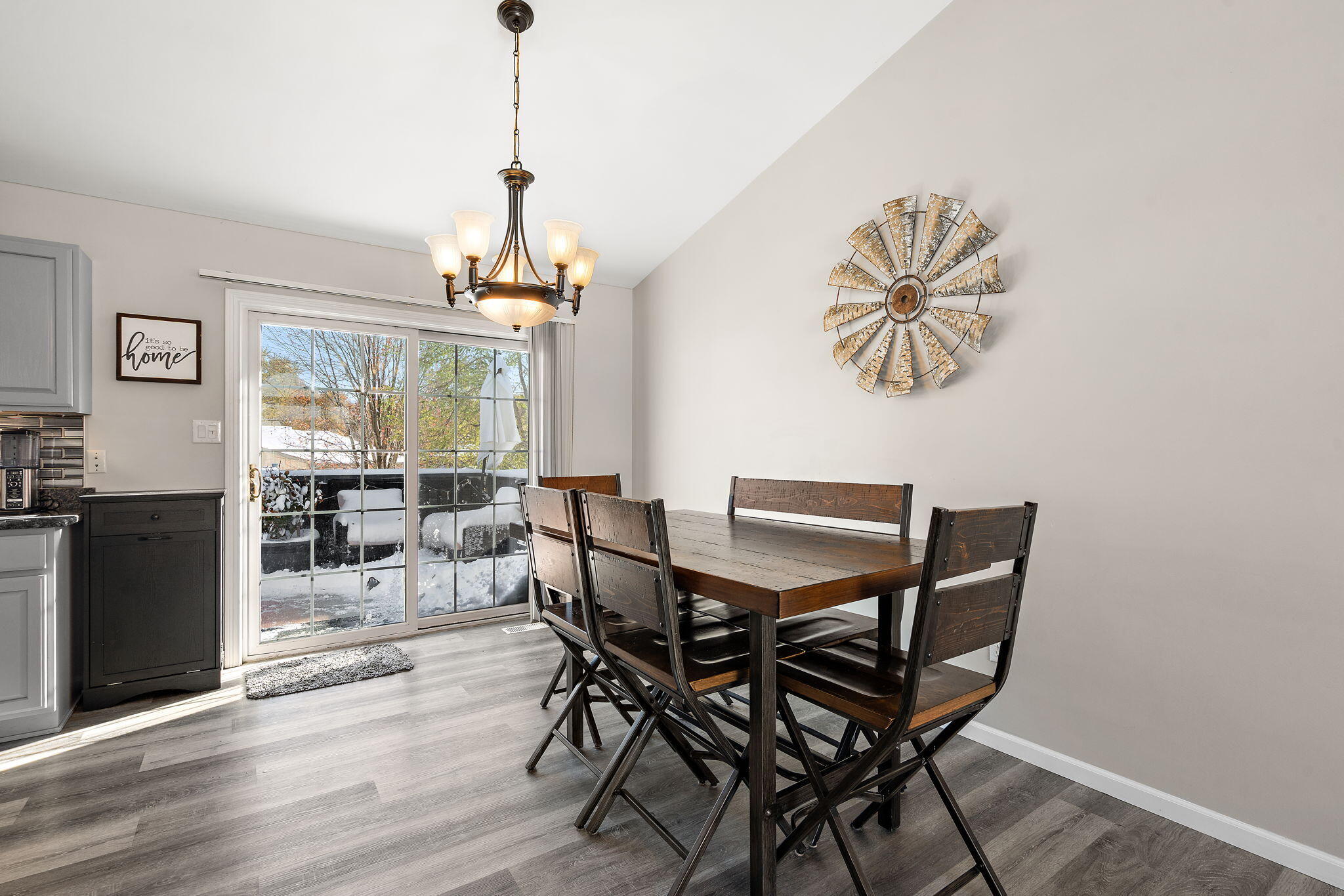 696 Admiral Drive Porter, IN 46304 - Photo 11 of 27 a dining room with furniture a chandelier and wooden floor