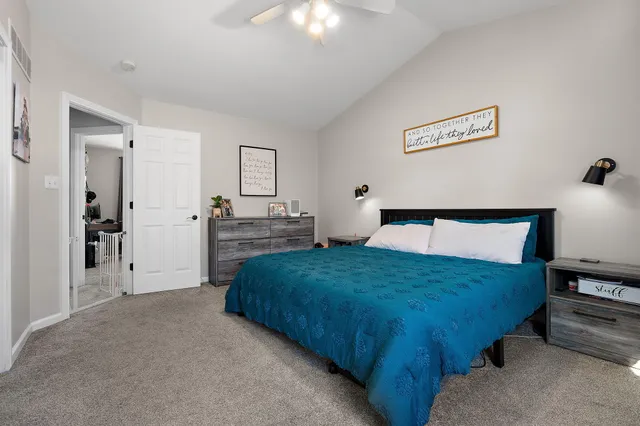 a bedroom with a bed and a chandelier