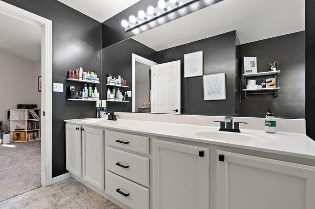 a bathroom with a double vanity sink and a mirror