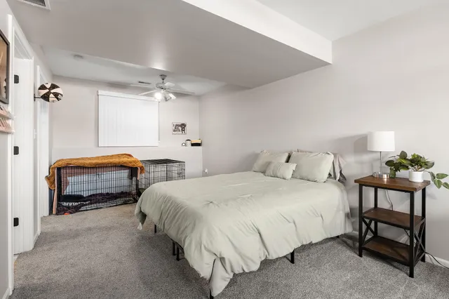 a bedroom with a bed and a chandelier