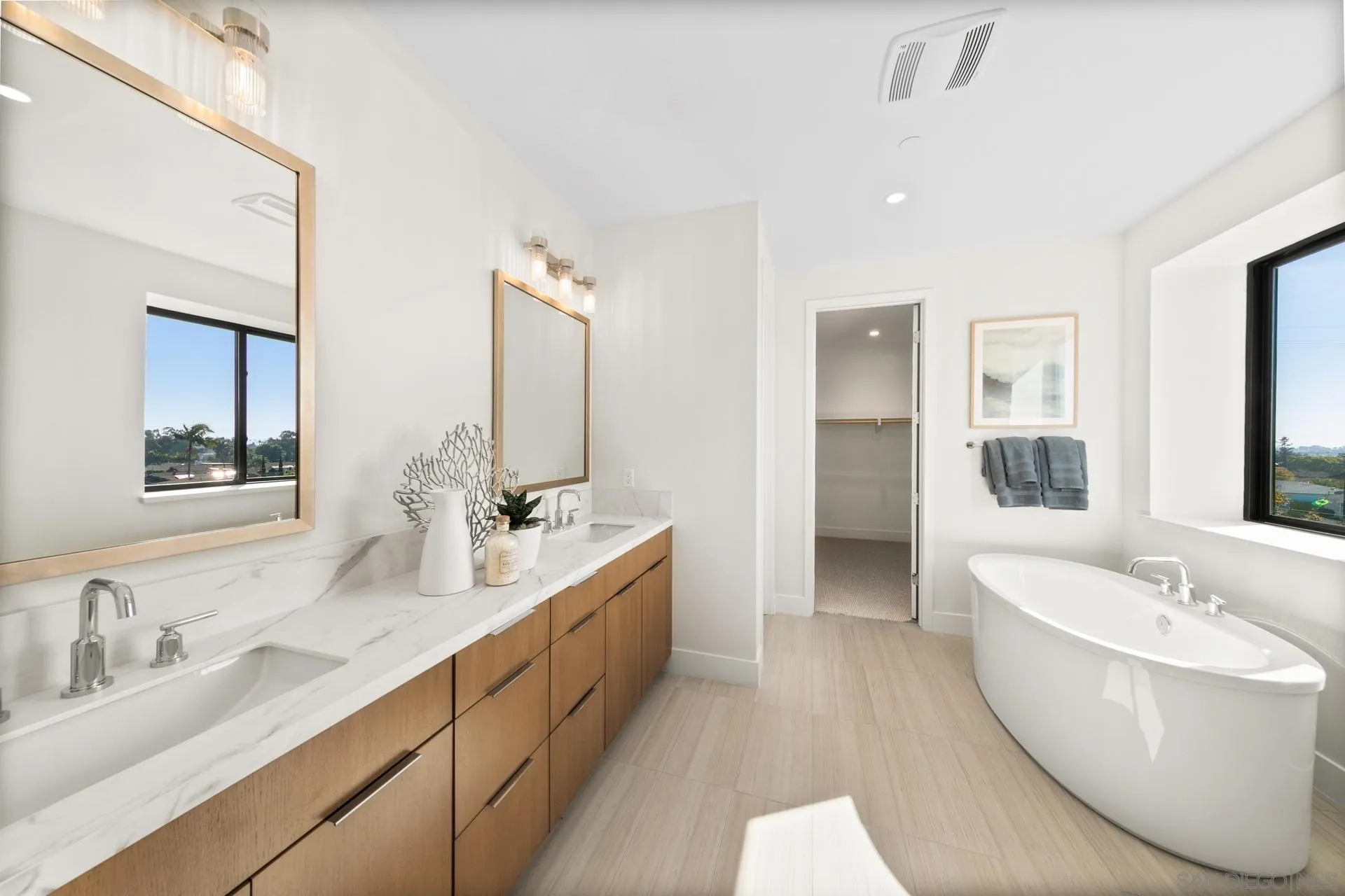 1756 Whaley Street Oceanside, CA 92054 - Photo 21 of 47 a bathroom with a double vanity sink tub double and mirror