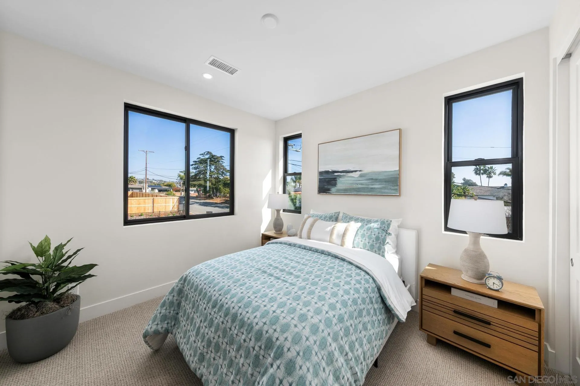 1756 Whaley Street Oceanside, CA 92054 - Photo 26 of 47 a bedroom with a bed and a painting on the wall