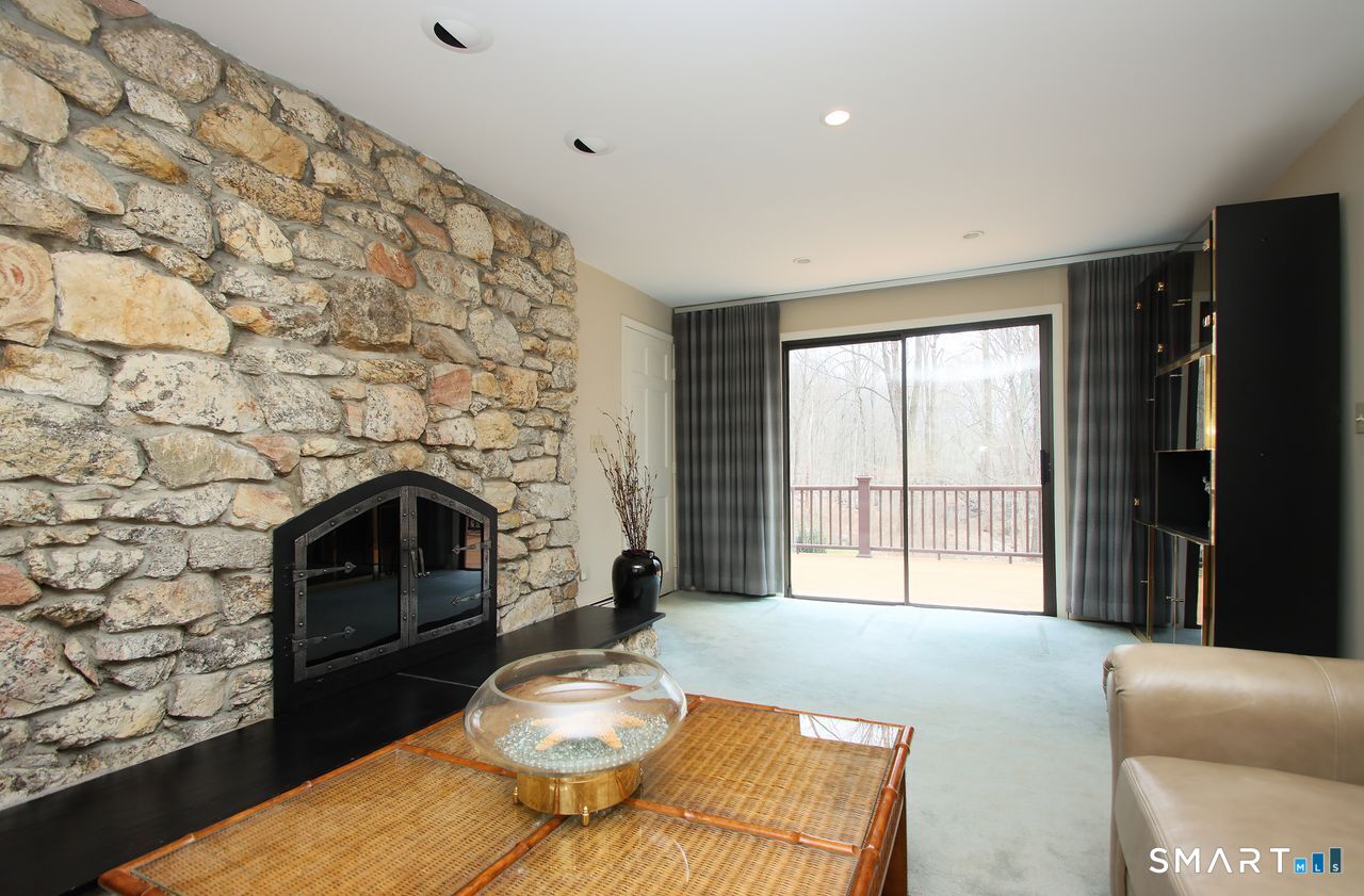 370 Opening Hill Road Madison, CT 06443 - Photo 11 of 27 Large fireplace and sliding glass door to deck