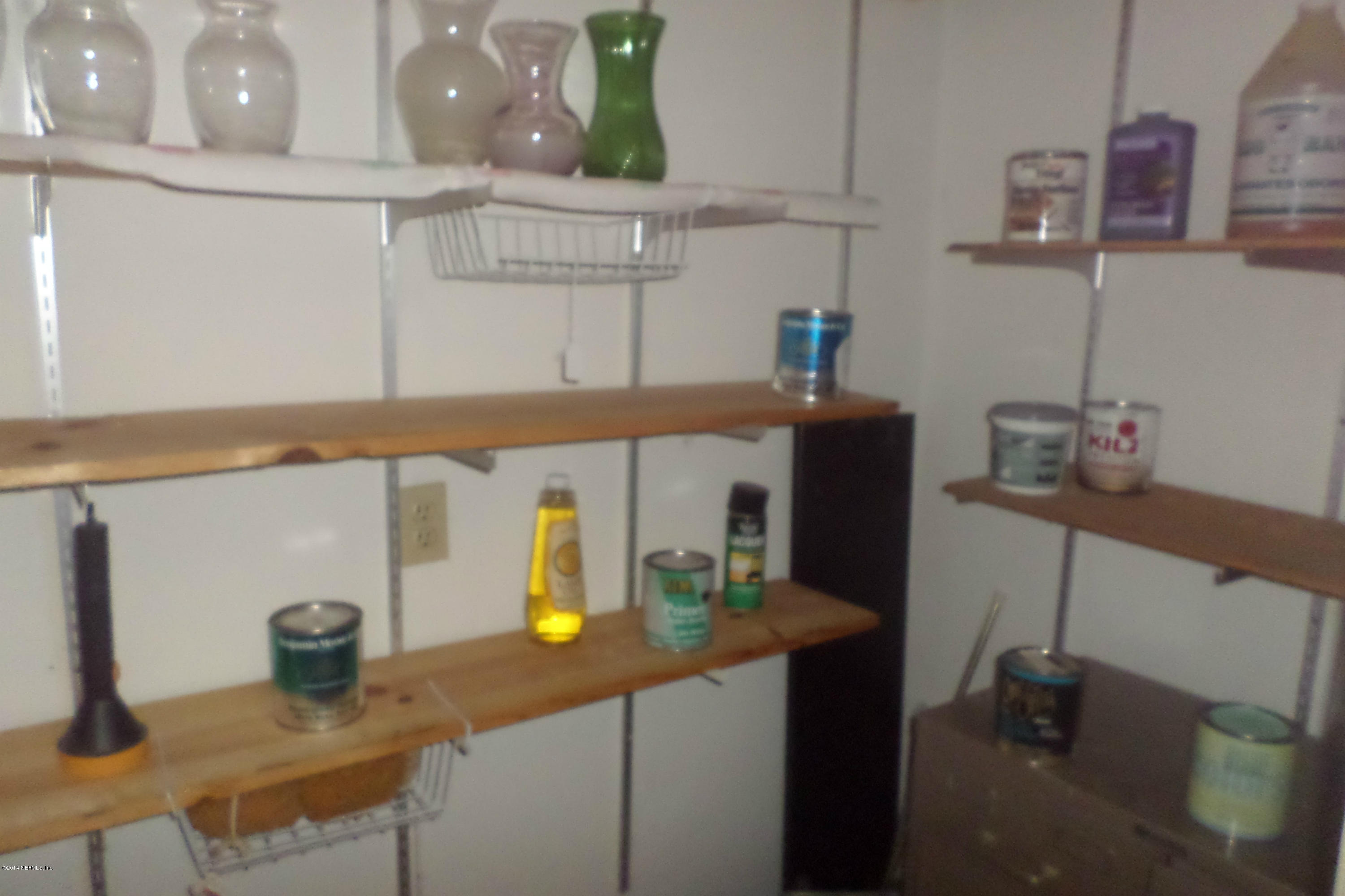 4822 Windrush Lane Jacksonville, FL 32217 - Photo 19 of 23 a kitchen with a sink a refrigerator and wooden cabinets