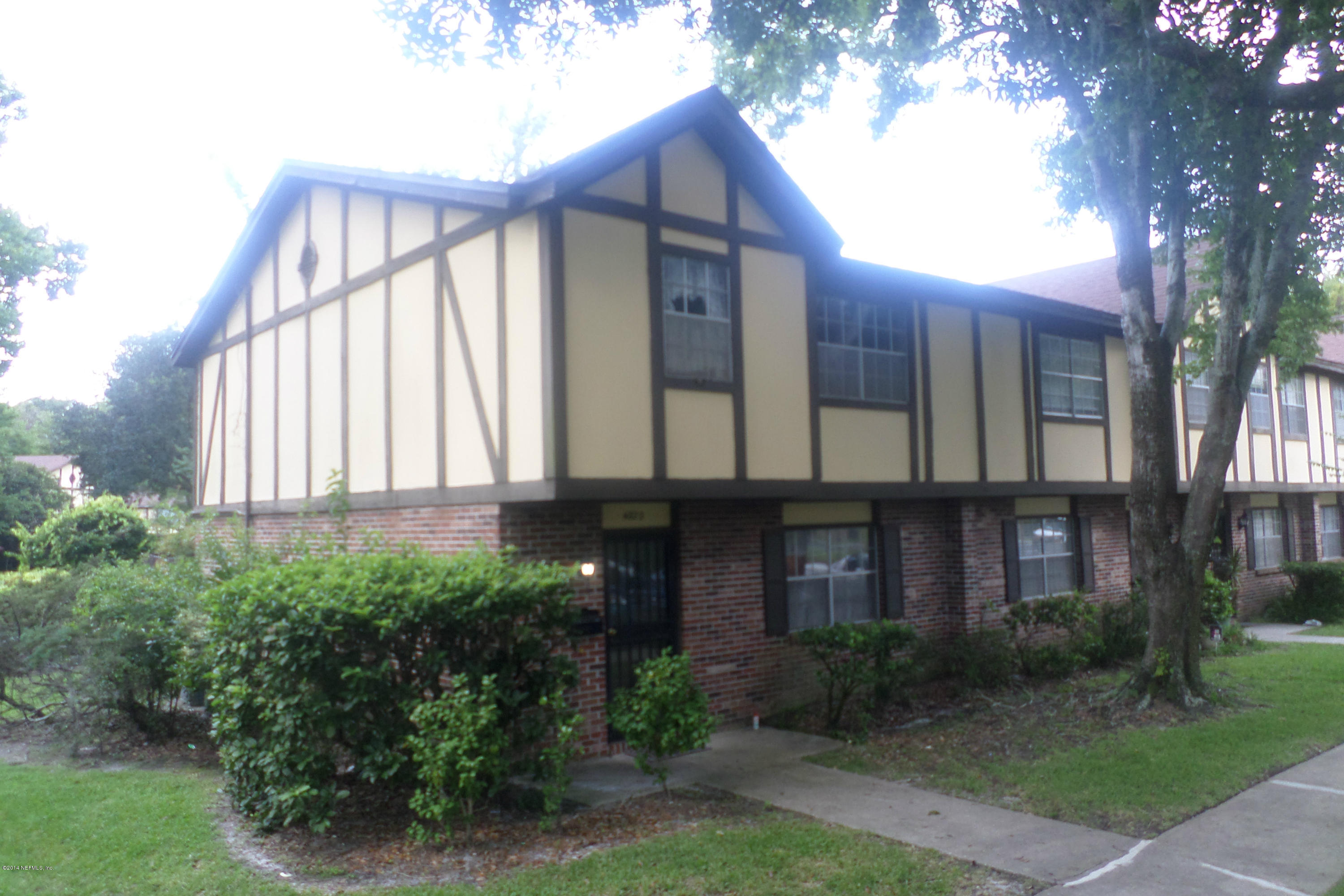4822 Windrush Lane Jacksonville, FL 32217 - Photo 2 of 23 a brick building with a large windows