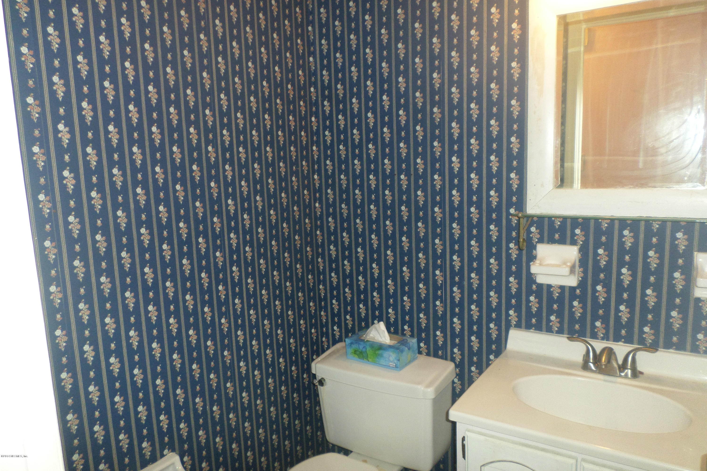 4822 Windrush Lane Jacksonville, FL 32217 - Photo 22 of 23 a bathroom with a toilet a sink and mirror