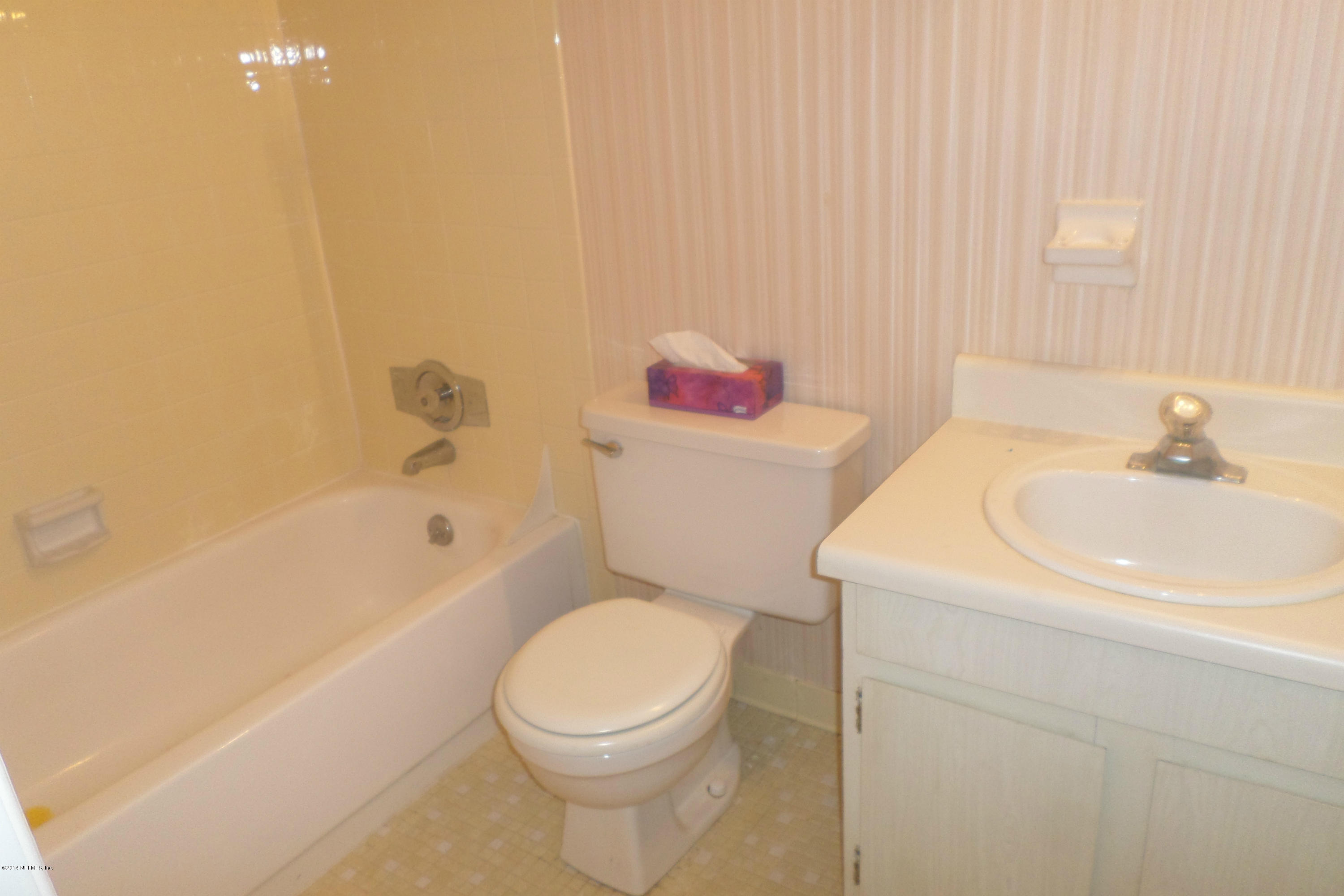 4822 Windrush Lane Jacksonville, FL 32217 - Photo 23 of 23 a white toilet sitting next to a bathroom sink
