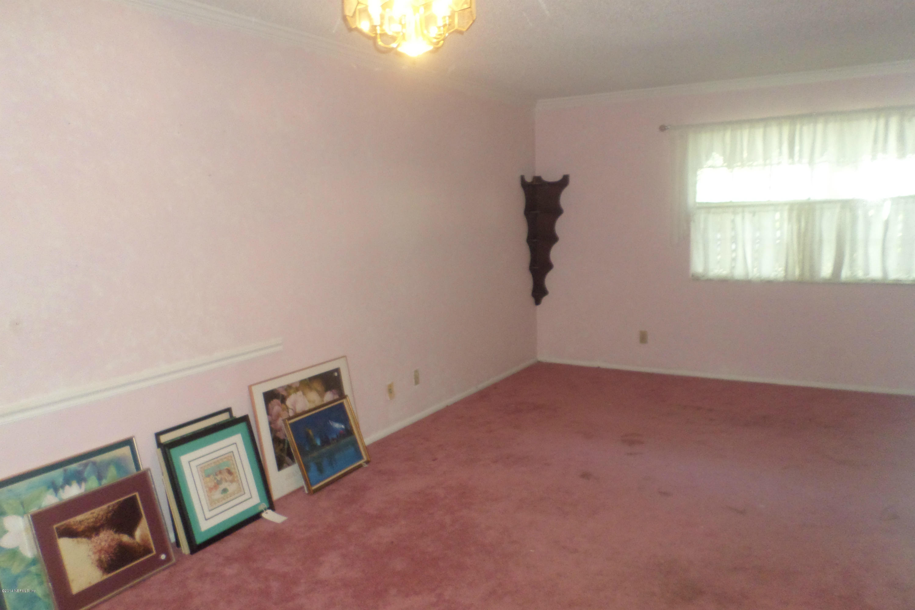 4822 Windrush Lane Jacksonville, FL 32217 - Photo 4 of 23 an empty room with windows