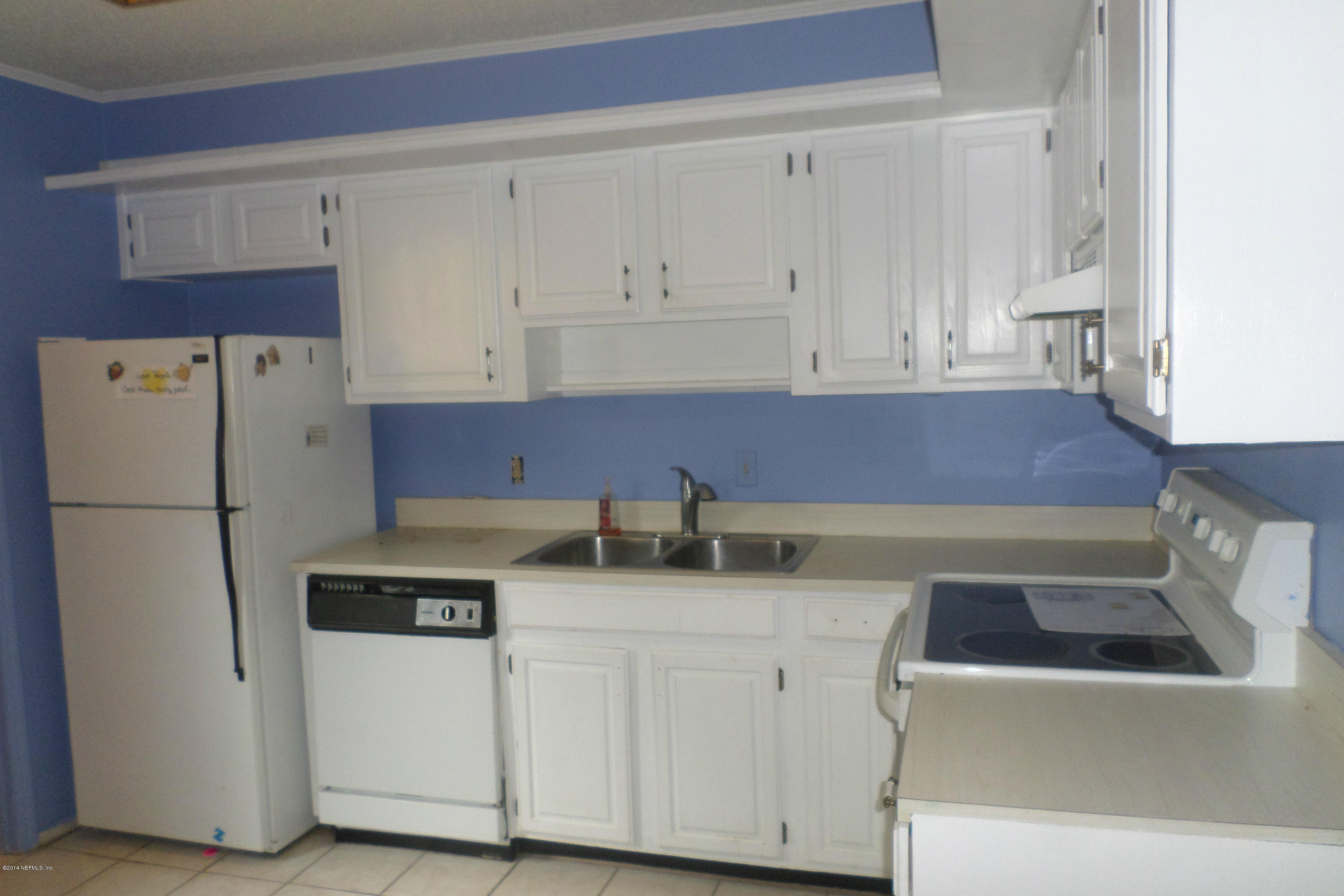 4822 Windrush Lane Jacksonville, FL 32217 - Photo 7 of 23 a kitchen with cabinets and white appliances