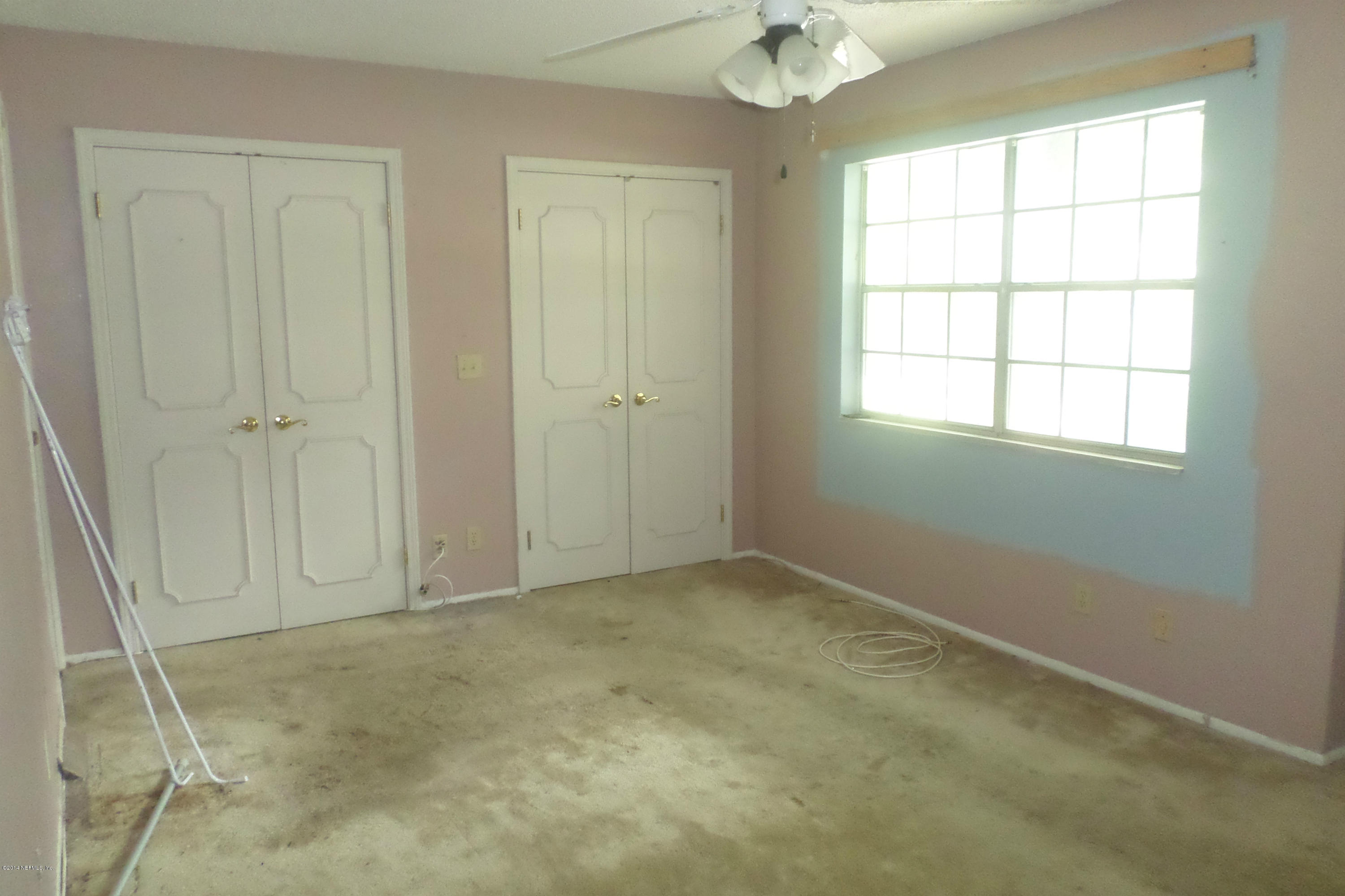 4822 Windrush Lane Jacksonville, FL 32217 - Photo 9 of 23 an empty room with a empty space and windows