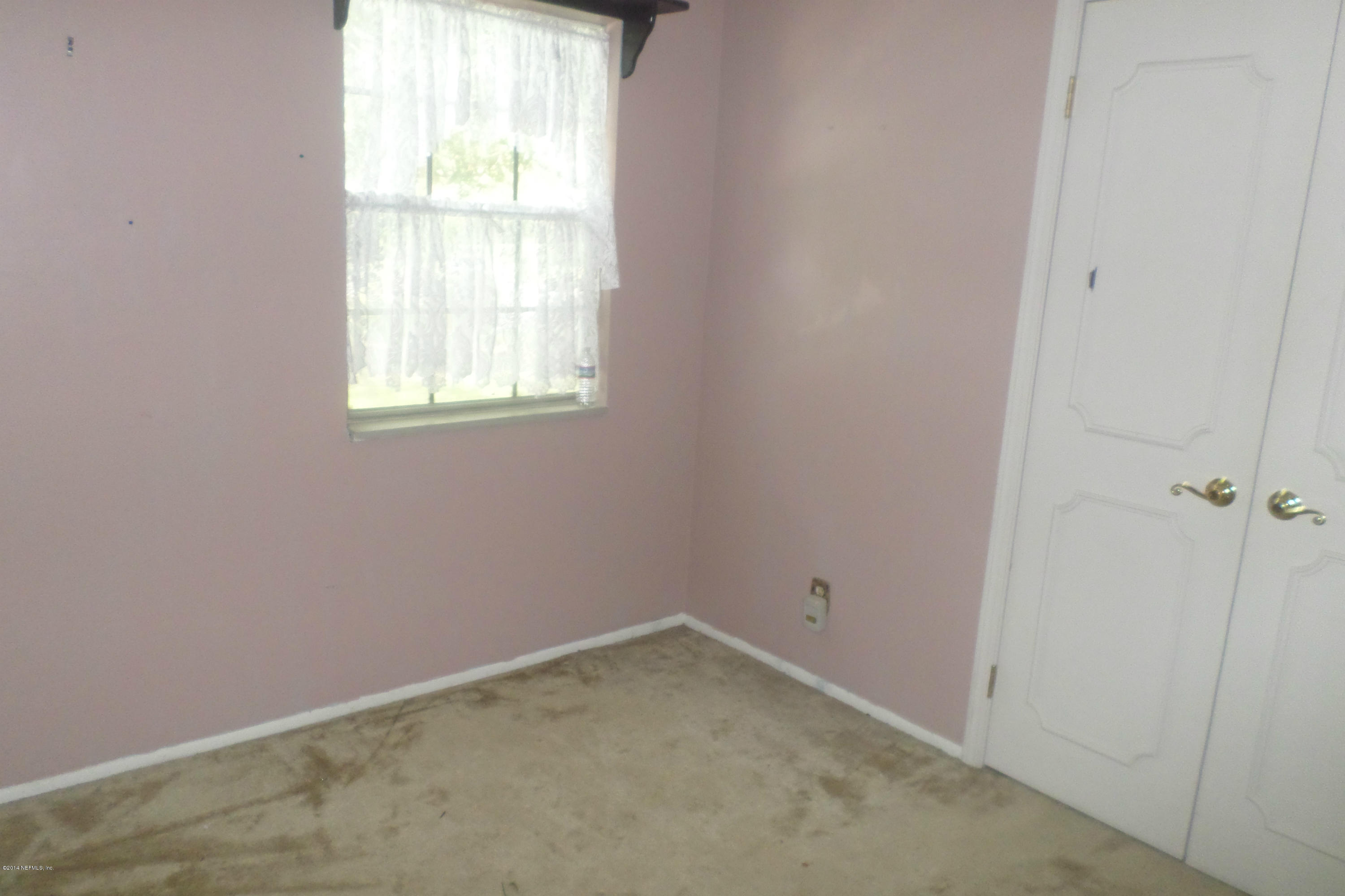 4822 Windrush Lane Jacksonville, FL 32217 - Photo 10 of 23 an empty room with a window
