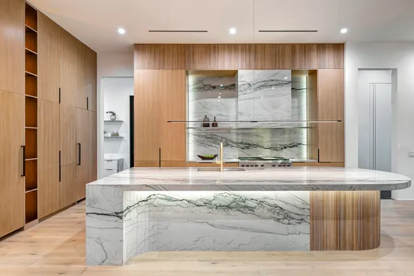 a bathroom with a granite countertop sink a large mirror and shower