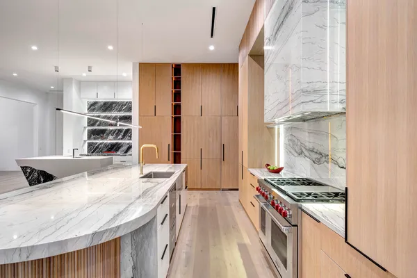 a living room with furniture large windows and flat screen tv