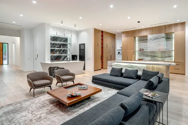 a view of a livingroom with furniture wooden floor and a ceiling fan