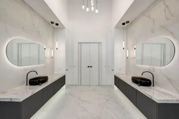 a bathroom with a double vanity sink mirror and shower
