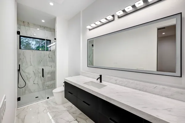 a view of an empty room with a fireplace and a window