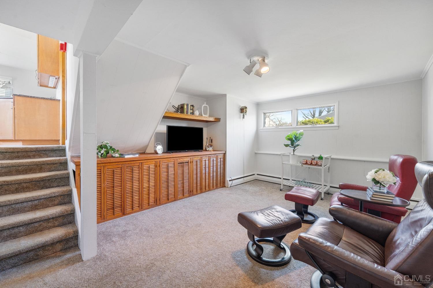 22 Baldwin Road Edison, NJ 08817 - Photo 13 of 30 a living room with furniture and a flat screen tv
