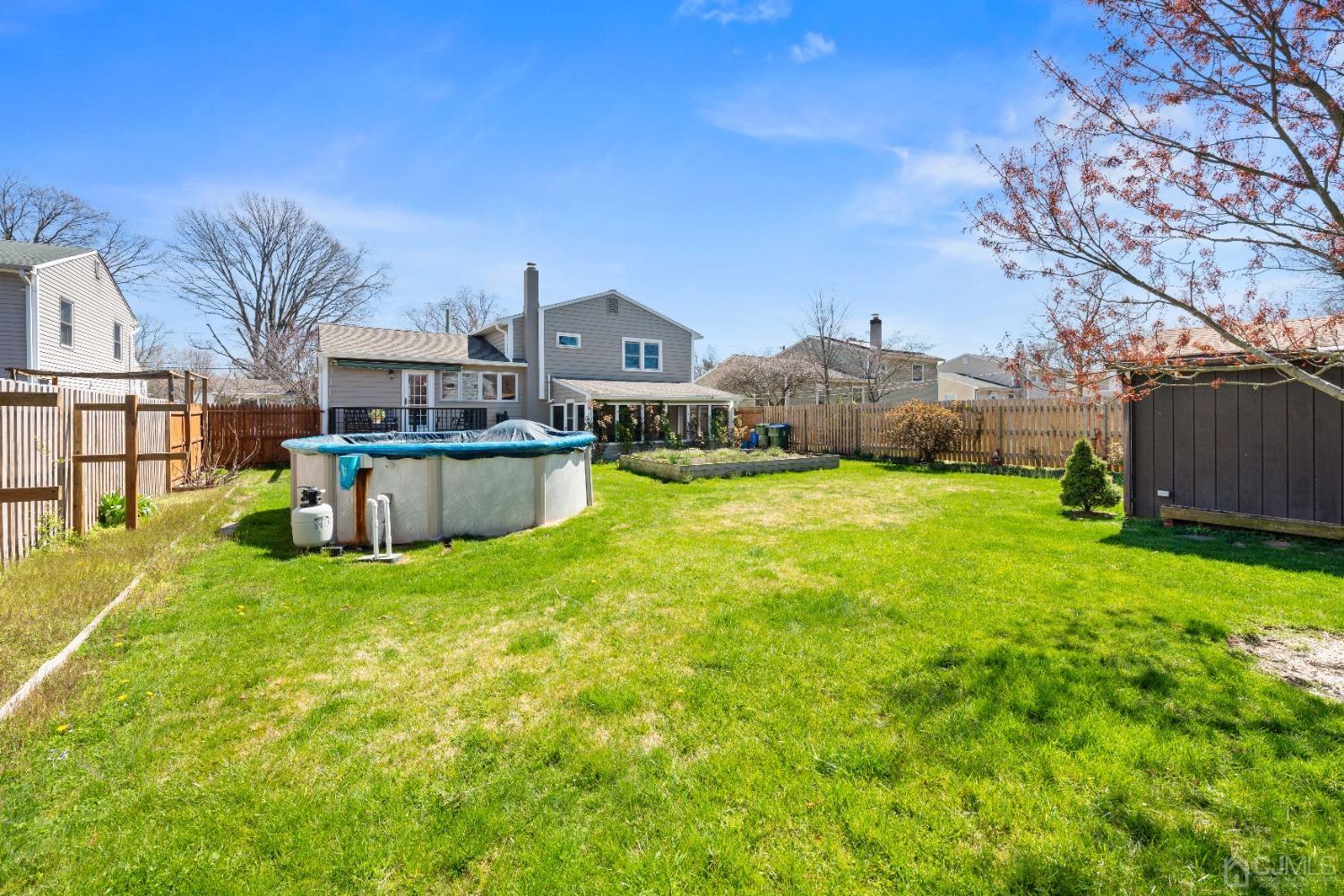 22 Baldwin Road Edison, NJ 08817 - Photo 19 of 30 a view of a house with a big yard and a large tree