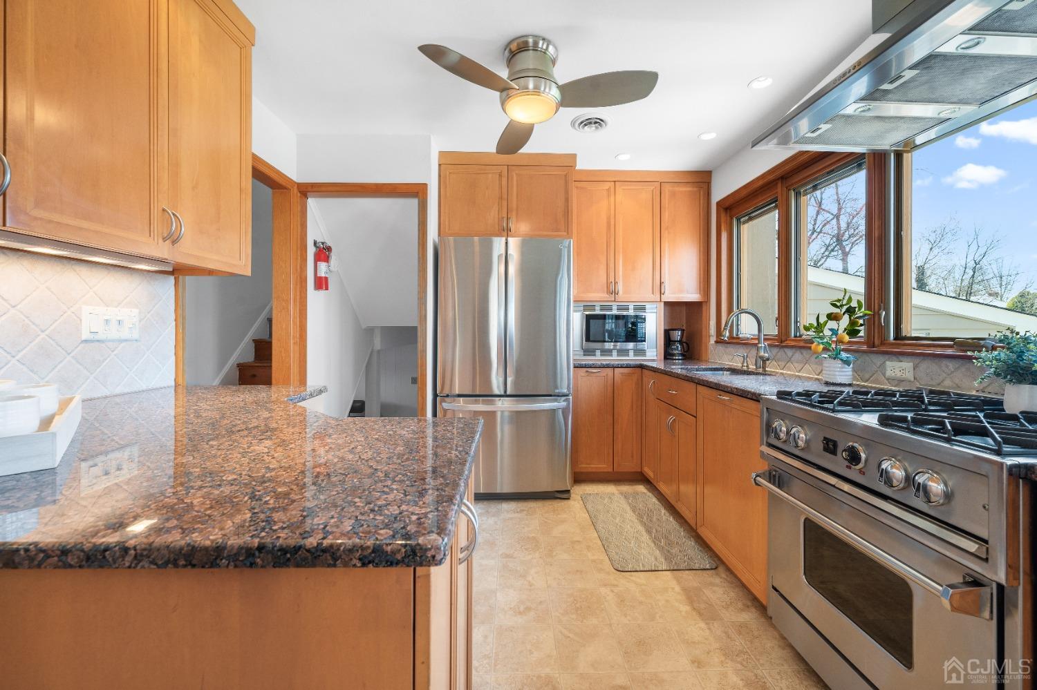 22 Baldwin Road Edison, NJ 08817 - Photo 2 of 30 a kitchen with stainless steel appliances granite countertop a stove a refrigerator and a sink