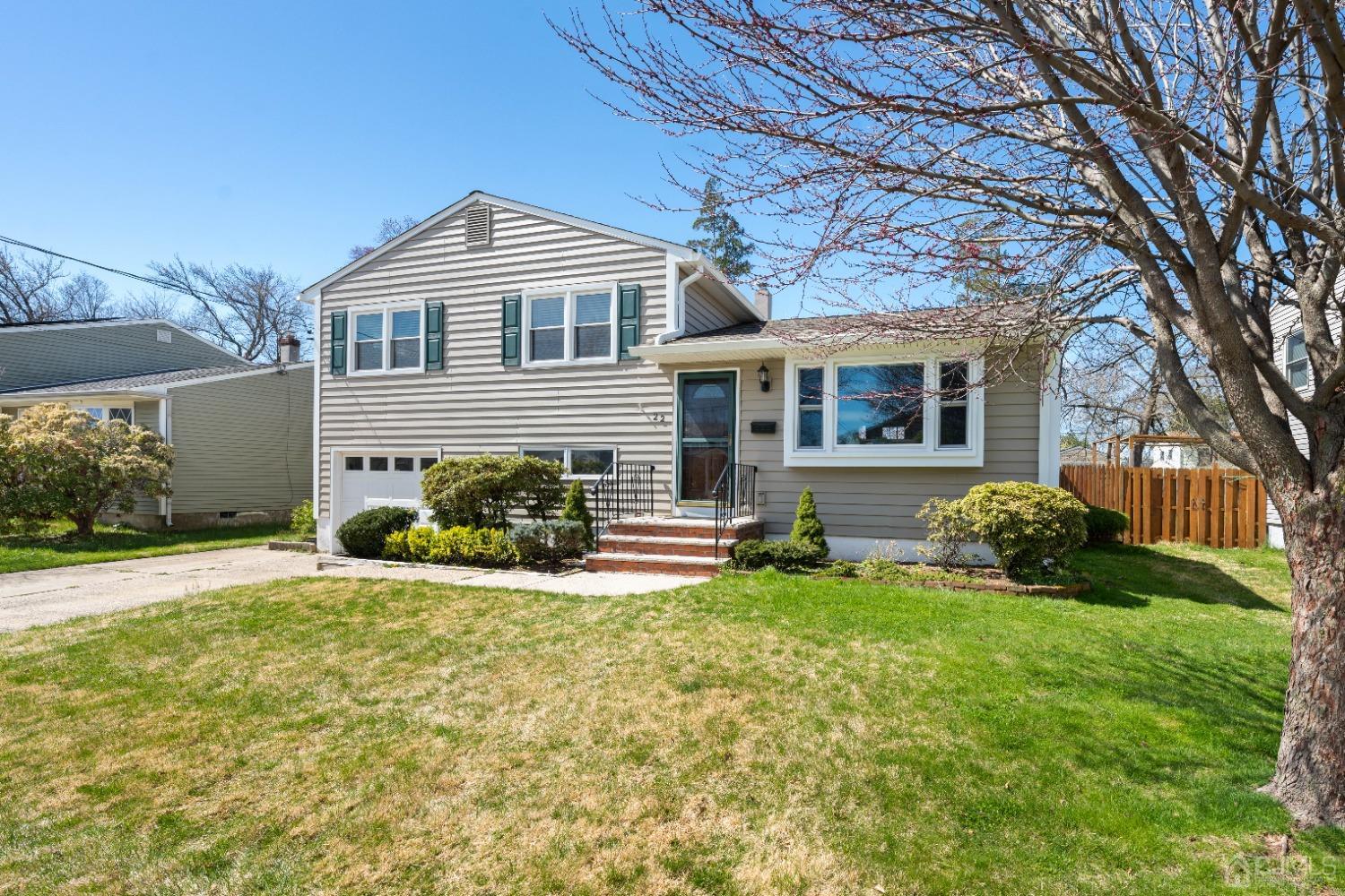22 Baldwin Road Edison, NJ 08817 - Photo 29 of 30 a front view of a house with a yard and outdoor seating