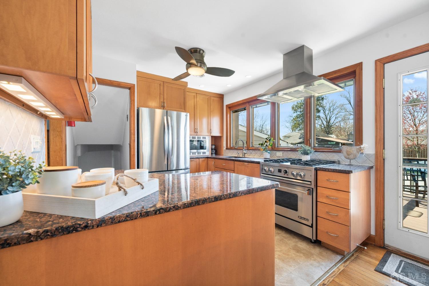 22 Baldwin Road Edison, NJ 08817 - Photo 3 of 30 a kitchen with stainless steel appliances granite countertop a sink stove and refrigerator