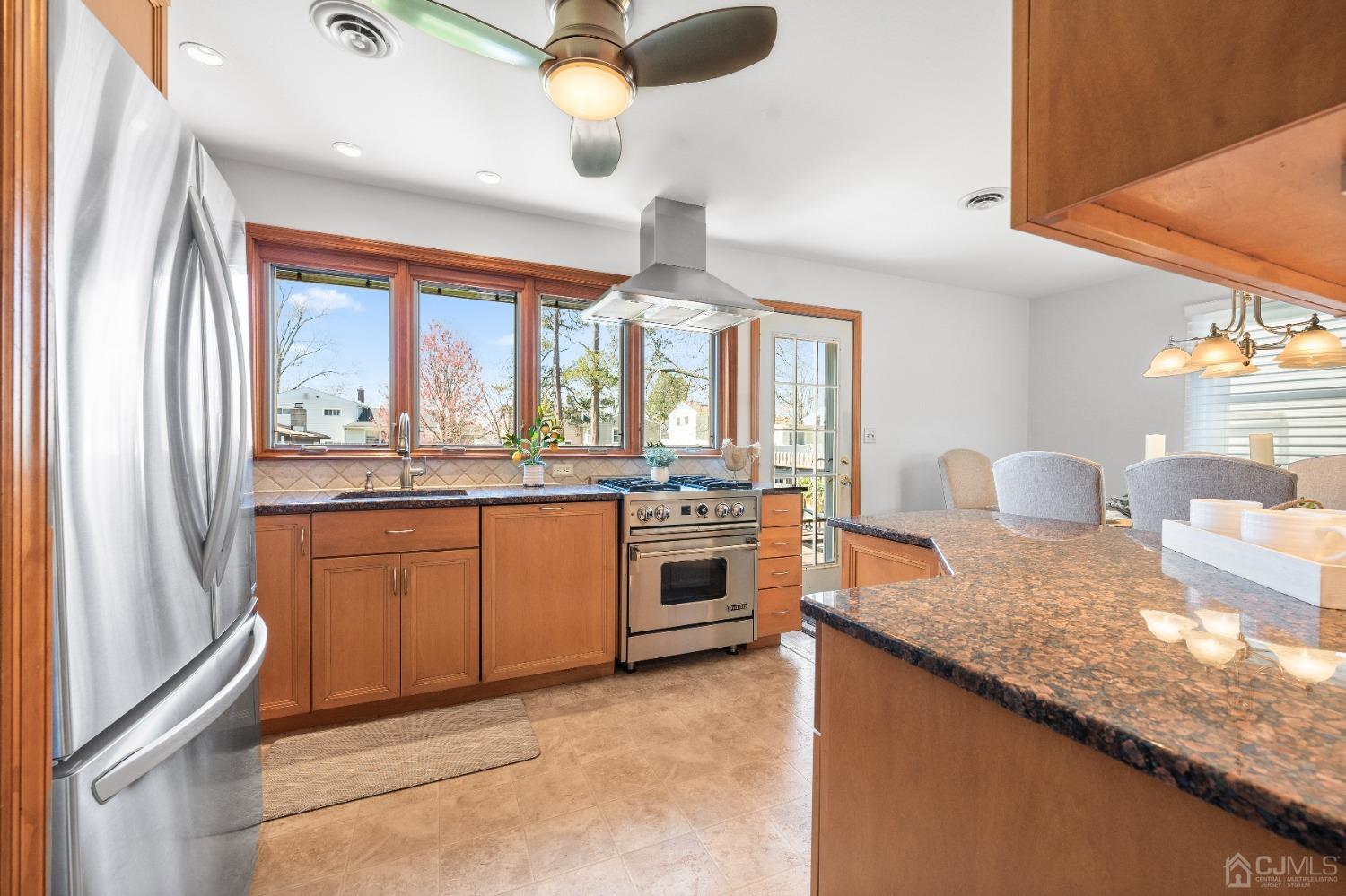 22 Baldwin Road Edison, NJ 08817 - Photo 4 of 30 a kitchen with stainless steel appliances granite countertop a sink and a refrigerator