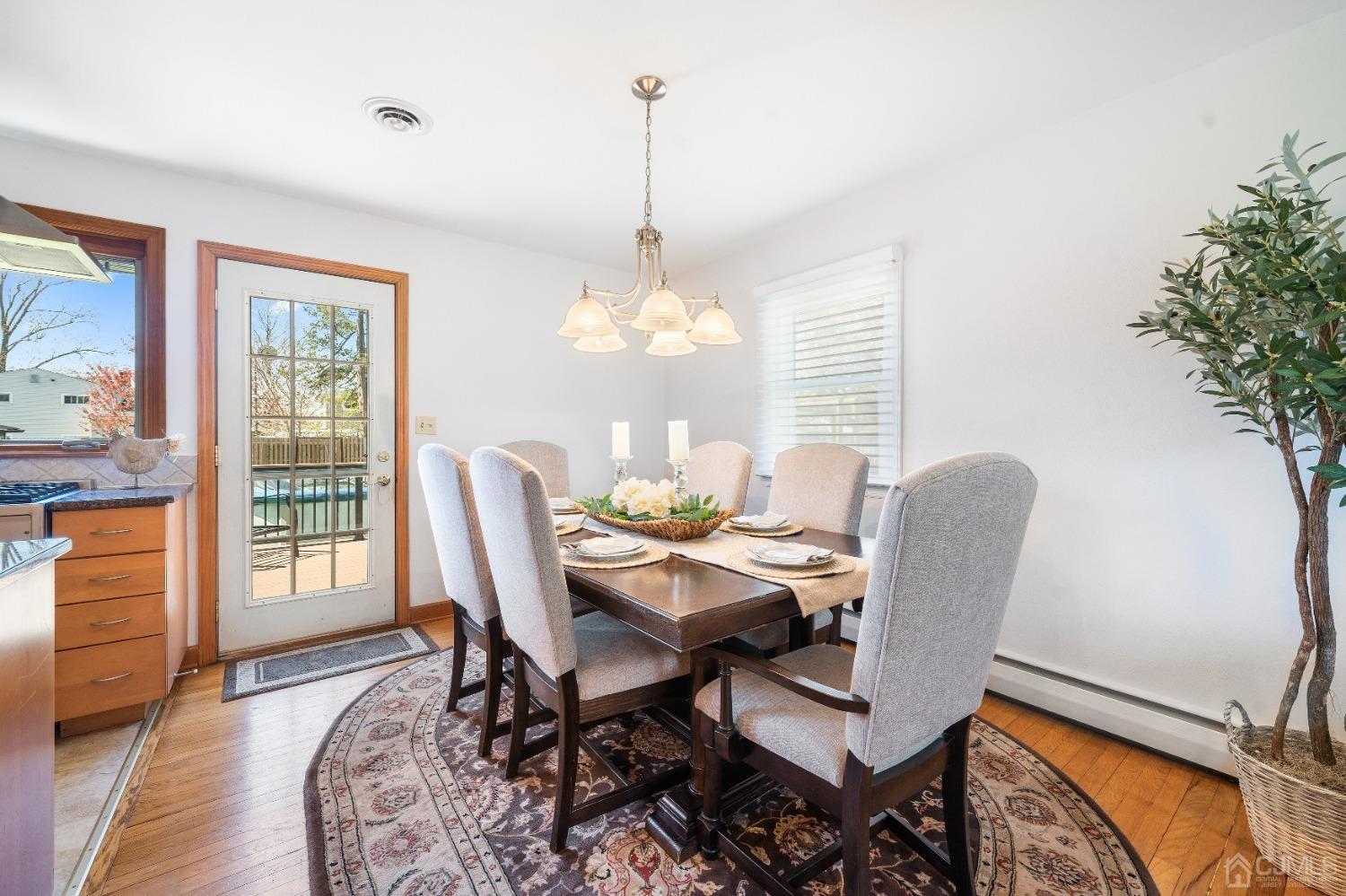 22 Baldwin Road Edison, NJ 08817 - Photo 6 of 30 a dining room with furniture a chandelier and wooden floor