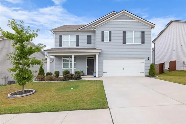 a front view of a house with a yard