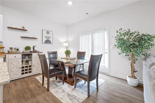 a view of a dining room with furniture and wooden floor