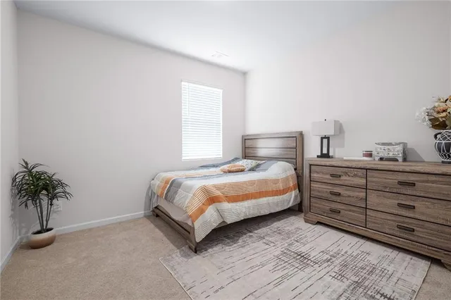 a bedroom with a bed and a potted plant