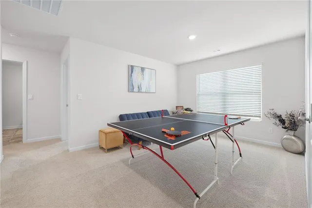 a room with furniture pool table and windows