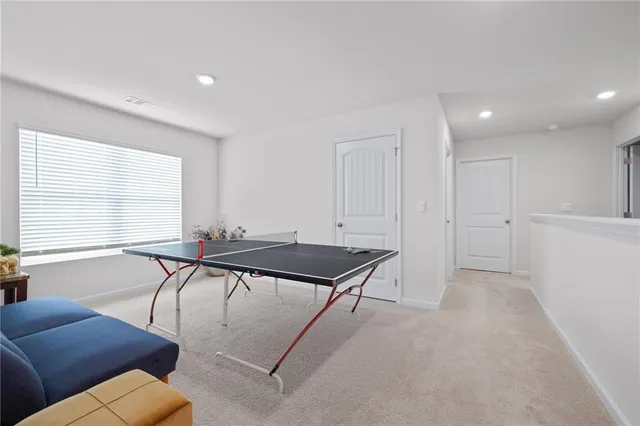 a room with furniture pool table and windows