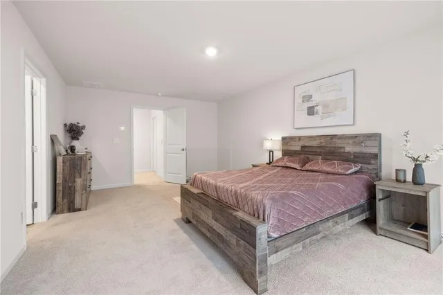 a spacious bedroom with a bed and a chandelier