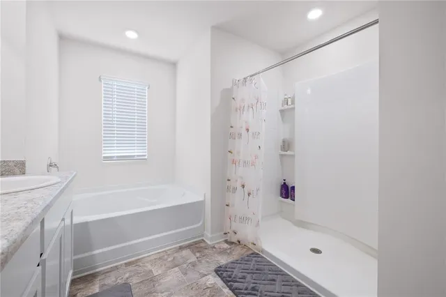 a bathroom with a shower a bathtub and a shower