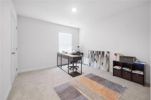 a living room with furniture a piano and a rug