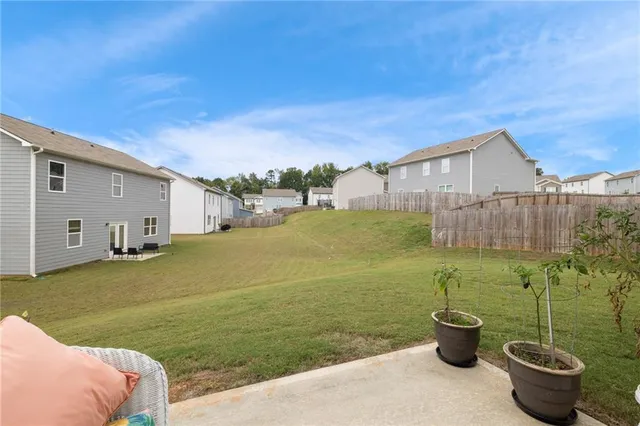 a view of a backyard with plants and a garden