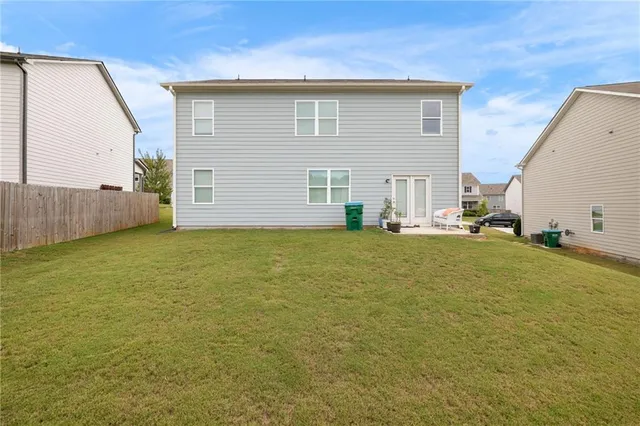 a view of a house with a backyard