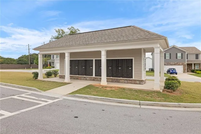 a view of a house with a swimming pool and a yard with potted plants