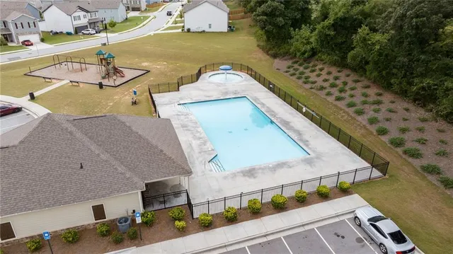 an aerial view of a house with outdoor space and lake view