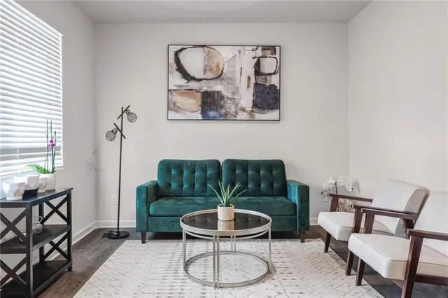 a living room with furniture and a potted plant
