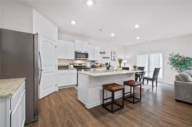 a kitchen with white cabinets and stainless steel appliances
