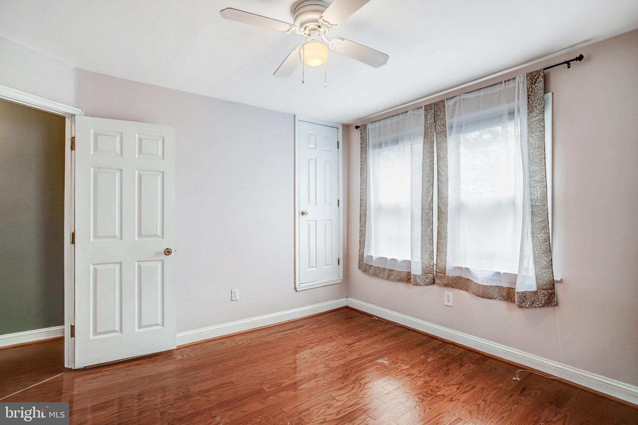 3026 Channing Street Northeast Washington, DC 20018 - Photo 11 of 24 a view of an empty room with window and wooden floor