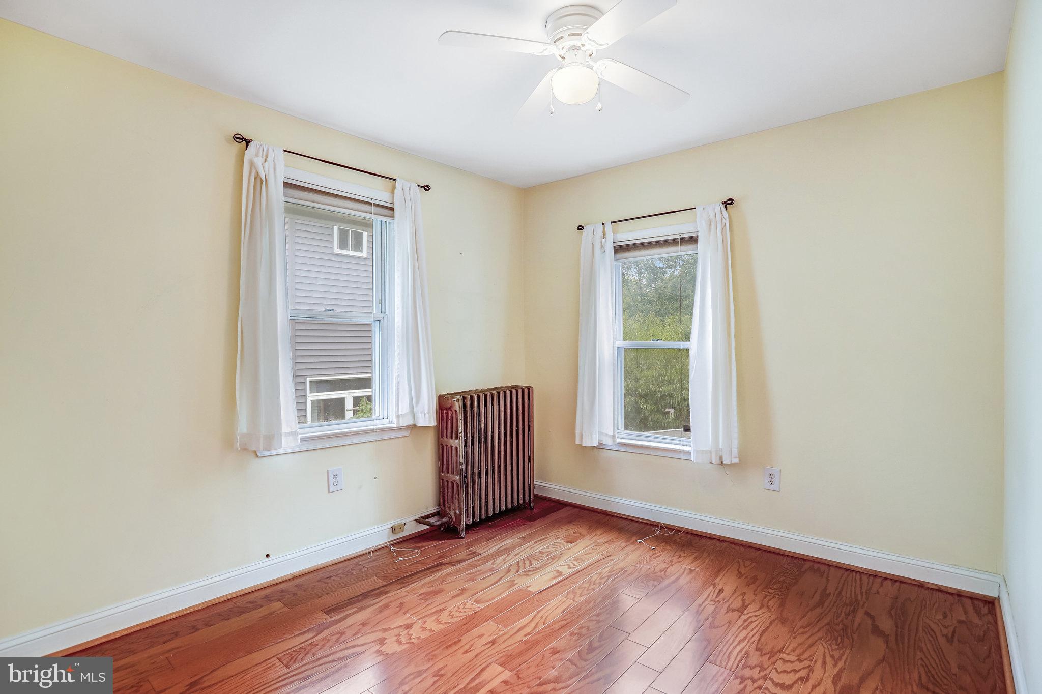 3026 Channing Street Northeast Washington, DC 20018 - Photo 12 of 24 a view of an empty room with a window and wooden floor