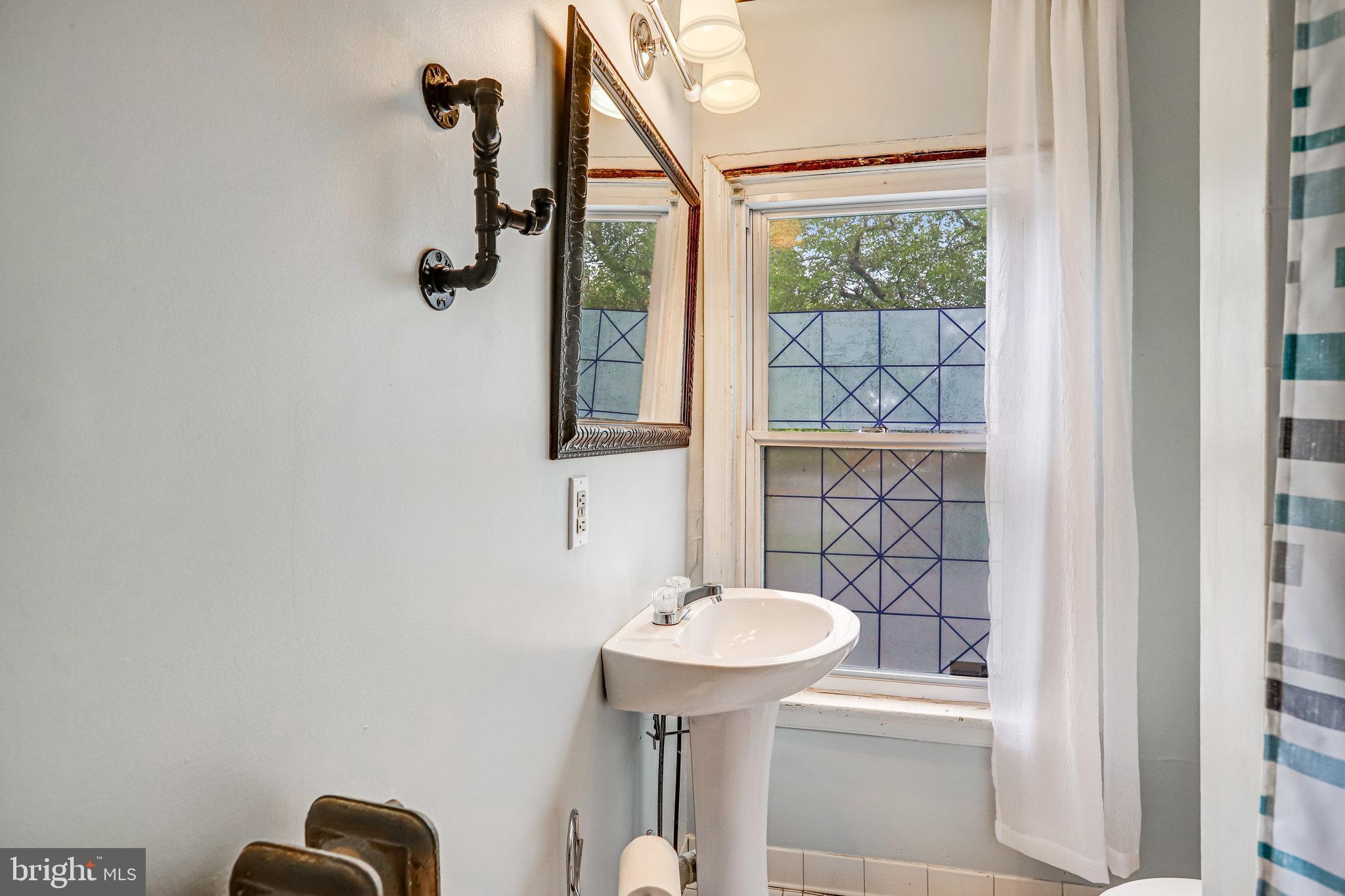 3026 Channing Street Northeast Washington, DC 20018 - Photo 14 of 24 a bathroom with a sink and mirror
