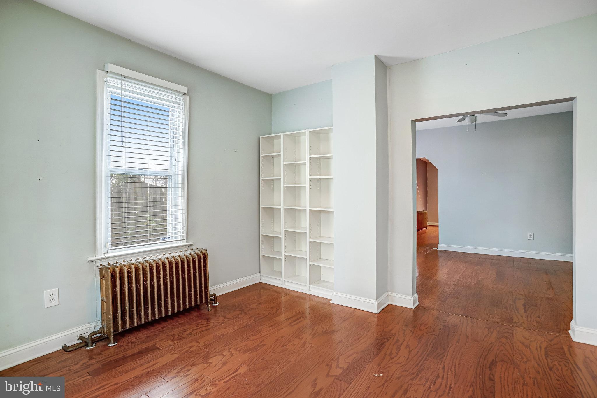 3026 Channing Street Northeast Washington, DC 20018 - Photo 4 of 24 an empty room with wooden floor closet and windows
