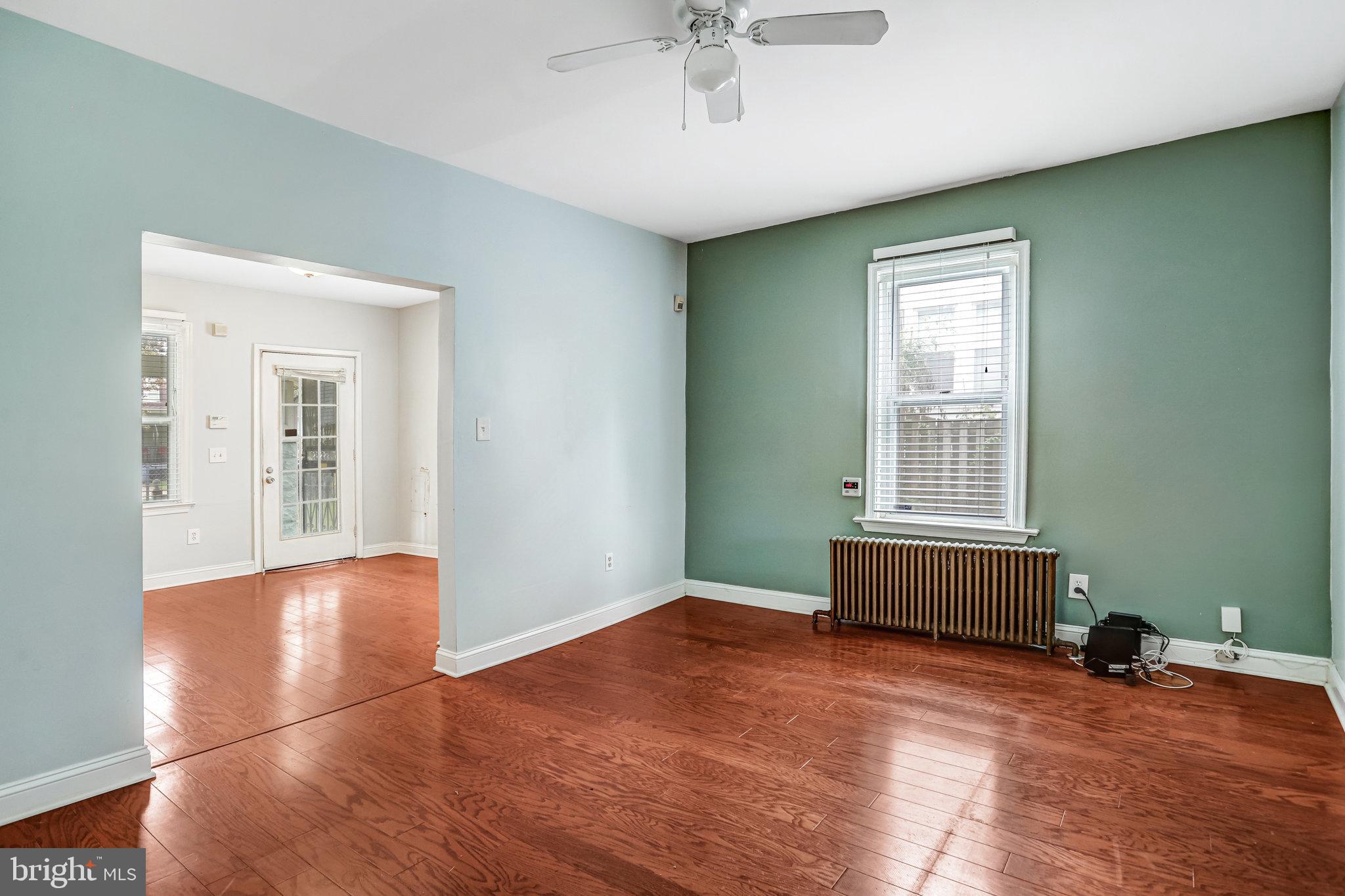 3026 Channing Street Northeast Washington, DC 20018 - Photo 5 of 24 an empty room with wooden floor and windows