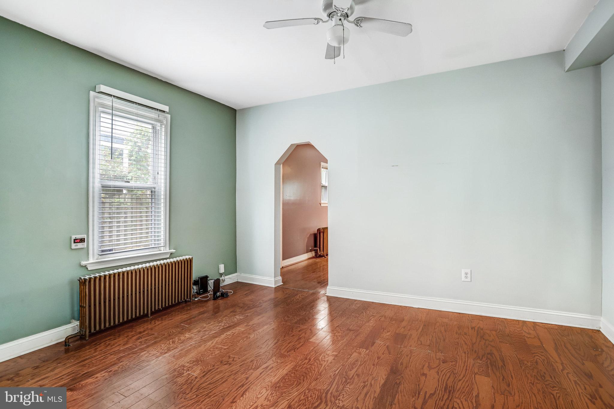 3026 Channing Street Northeast Washington, DC 20018 - Photo 6 of 24 an empty room with wooden floor and windows