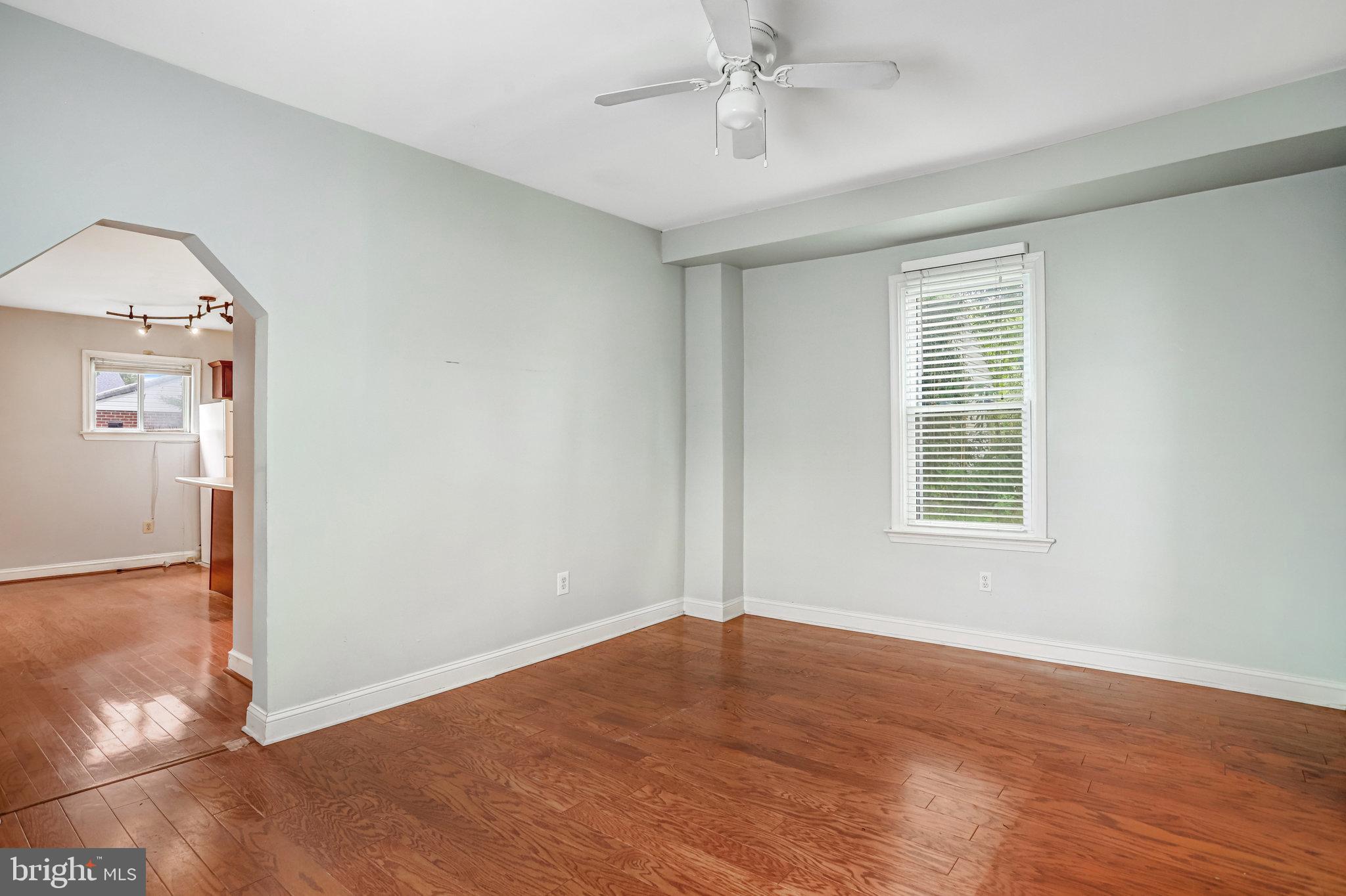 3026 Channing Street Northeast Washington, DC 20018 - Photo 7 of 24 an empty room with wooden floor fan and windows