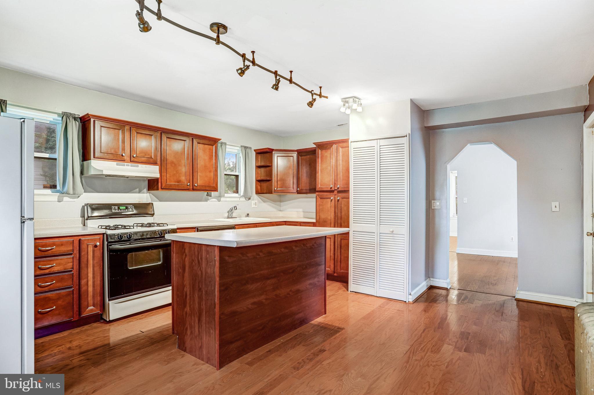 3026 Channing Street Northeast Washington, DC 20018 - Photo 8 of 24 a kitchen with stainless steel appliances granite countertop a stove and a refrigerator